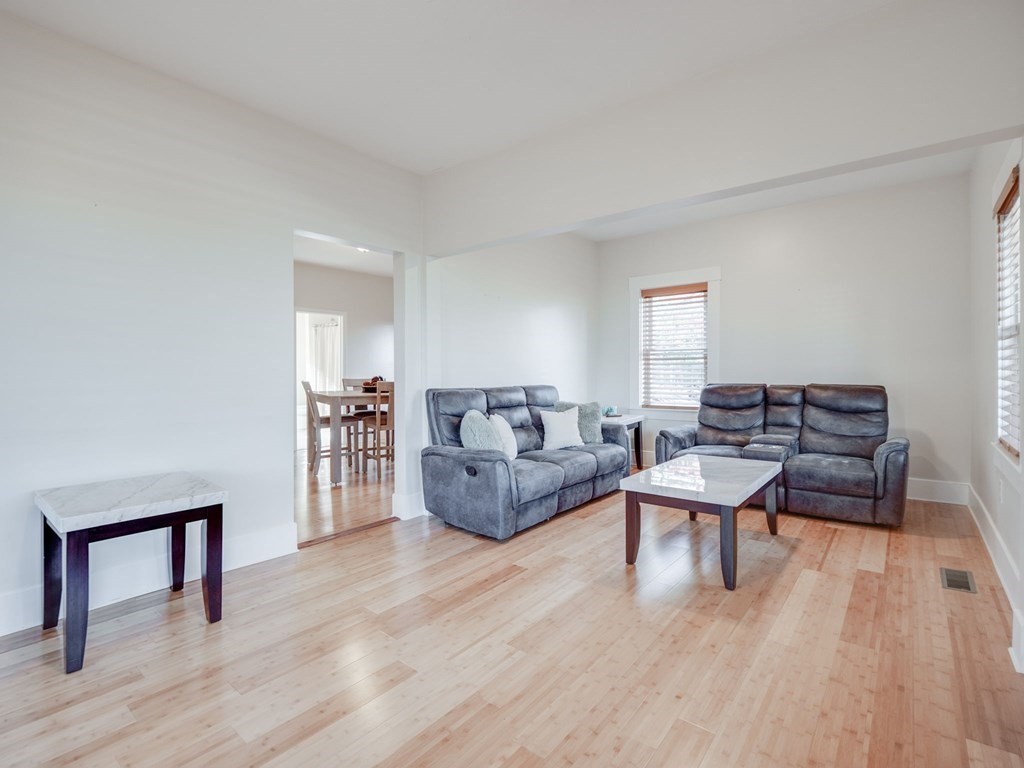 116 Middlesex Road Tyngsborough, MA 01879 - Photo 12 of 42 a living room with furniture and a wooden floor