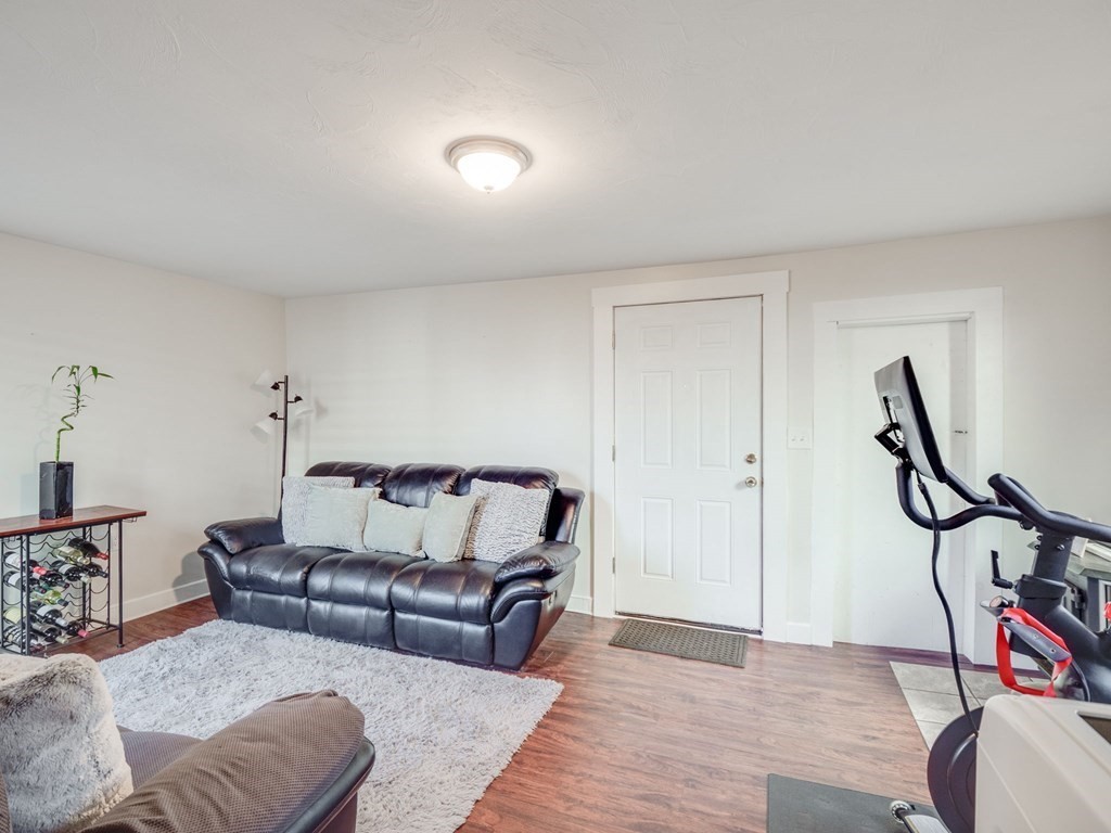 116 Middlesex Road Tyngsborough, MA 01879 - Photo 16 of 42 a living room with furniture and a wooden floor