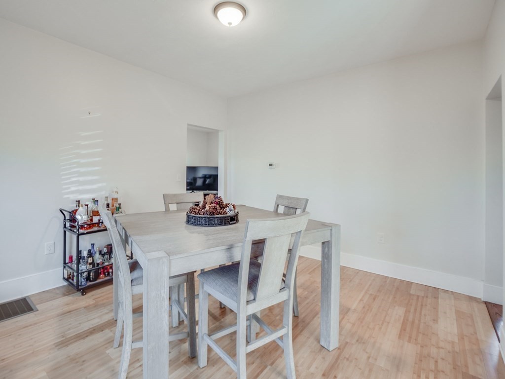 116 Middlesex Road Tyngsborough, MA 01879 - Photo 17 of 42 a view of a dining room with furniture and wooden floor