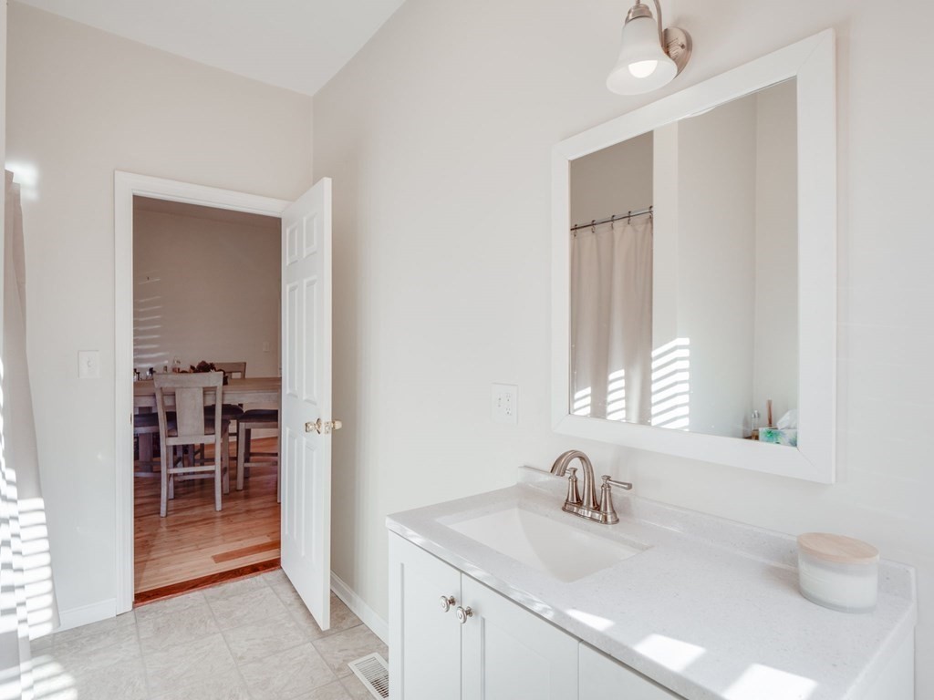 116 Middlesex Road Tyngsborough, MA 01879 - Photo 20 of 42 a bathroom with a sink vanity and a mirror