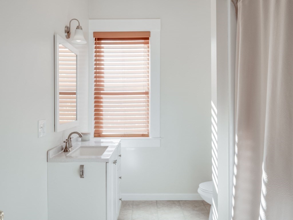 116 Middlesex Road Tyngsborough, MA 01879 - Photo 21 of 42 a bathroom with a window sink and vanity
