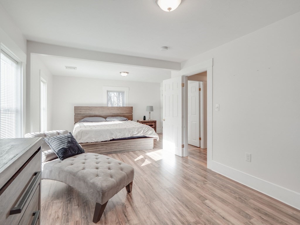 116 Middlesex Road Tyngsborough, MA 01879 - Photo 24 of 42 a bedroom with a bed and wooden floor