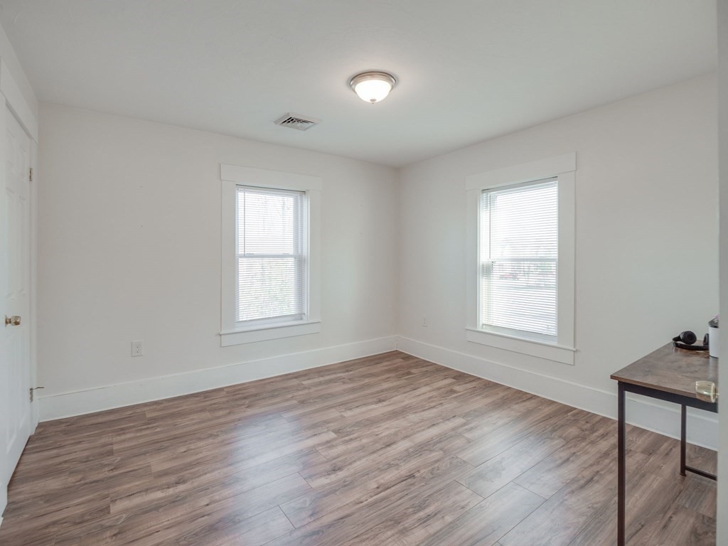 116 Middlesex Road Tyngsborough, MA 01879 - Photo 27 of 42 a view of an empty room with wooden floor and a window