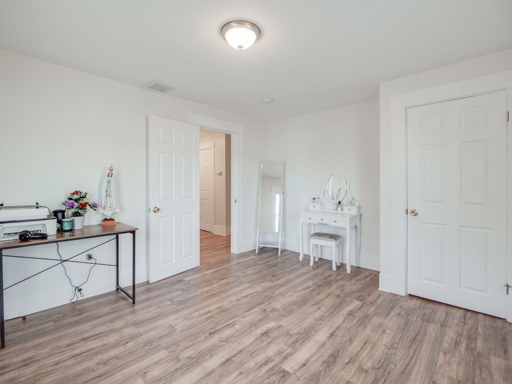 116 Middlesex Road Tyngsborough, MA 01879 - Photo 29 of 42 a view of a workspace with wooden floor and white cabinets