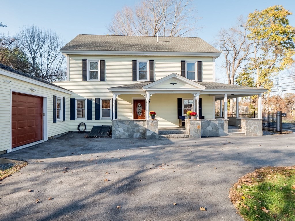 116 Middlesex Road Tyngsborough, MA 01879 - Photo 3 of 42 a view of a white house with large windows next to a road