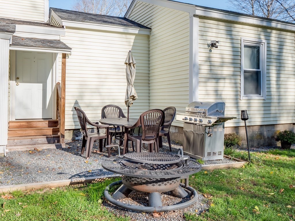 116 Middlesex Road Tyngsborough, MA 01879 - Photo 34 of 42 a table and chairs in a patio