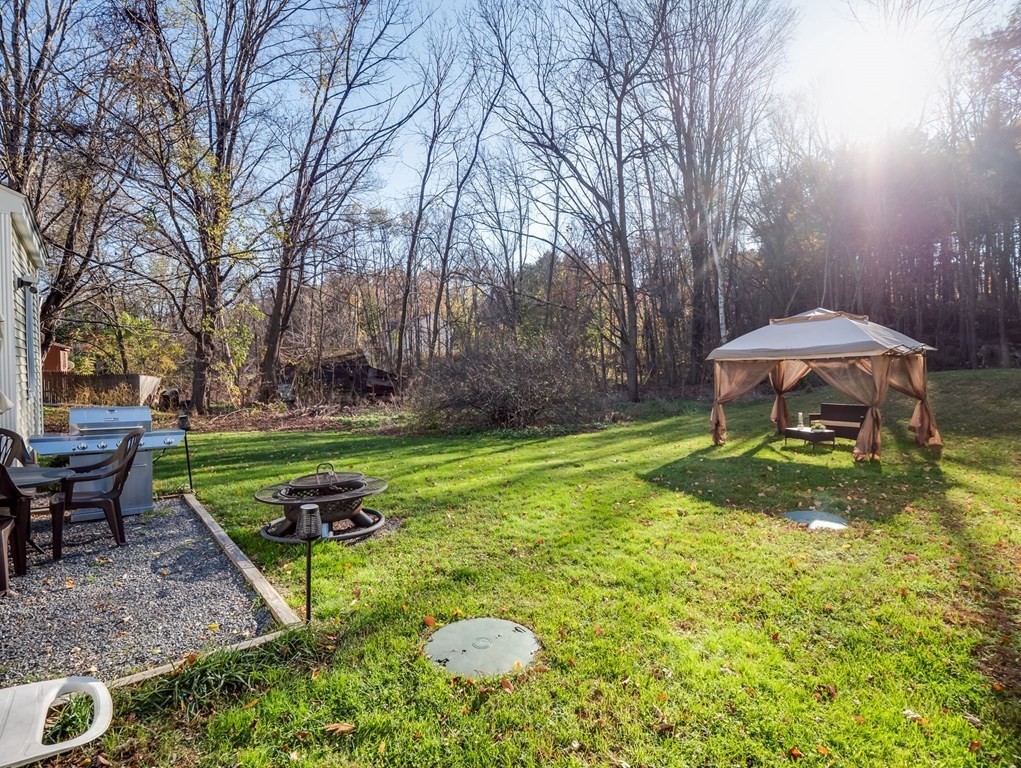 116 Middlesex Road Tyngsborough, MA 01879 - Photo 36 of 42 a backyard of a house with table and chairs