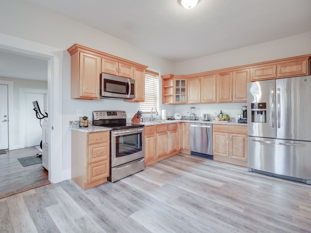 116 Middlesex Road Tyngsborough, MA 01879 - Photo 4 of 42 a kitchen with granite countertop a refrigerator stove top oven and sink