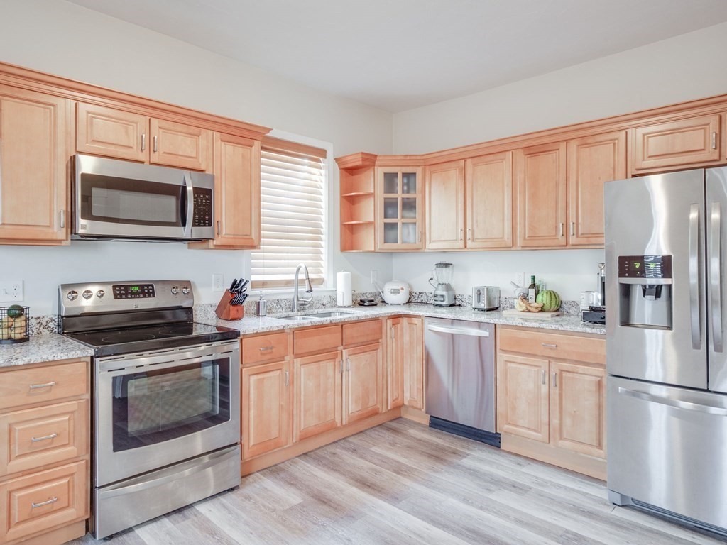 116 Middlesex Road Tyngsborough, MA 01879 - Photo 5 of 42 a kitchen with stainless steel appliances granite countertop a stove top oven a sink dishwasher and a refrigerator