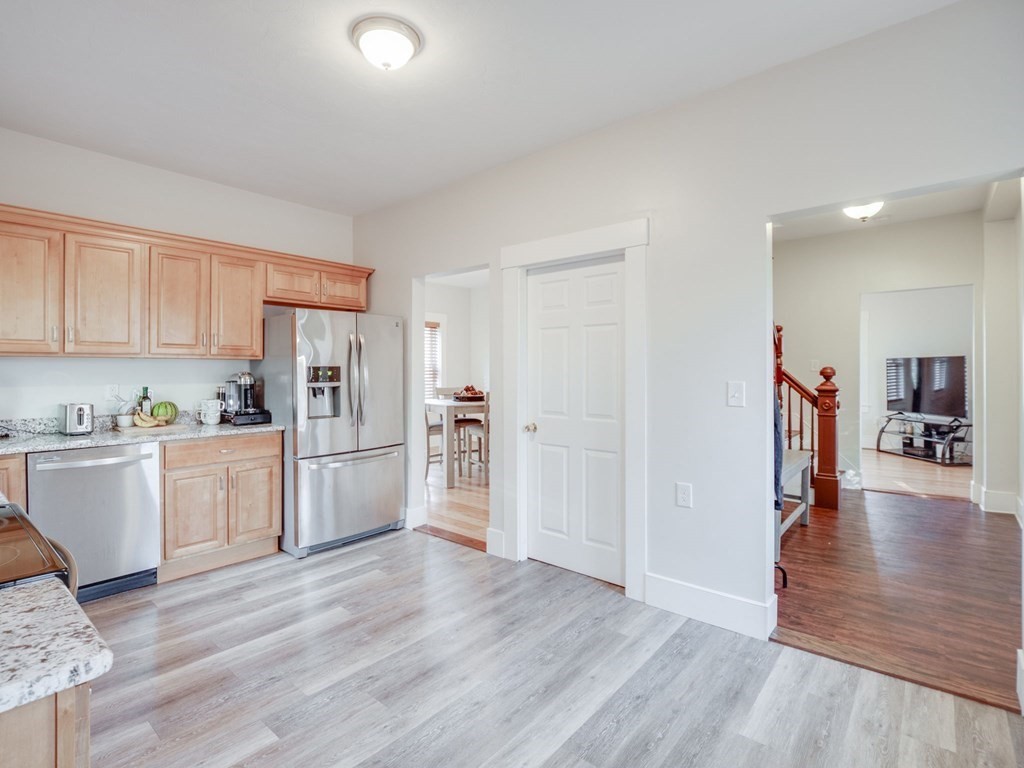 116 Middlesex Road Tyngsborough, MA 01879 - Photo 6 of 42 a kitchen with granite countertop a refrigerator and a stove top oven