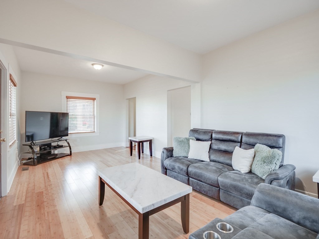 116 Middlesex Road Tyngsborough, MA 01879 - Photo 8 of 42 a living room with furniture and a flat screen tv