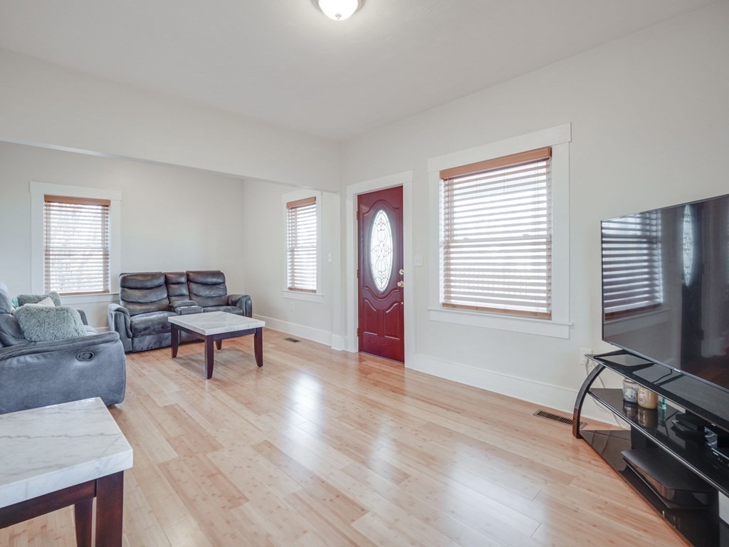 116 Middlesex Road Tyngsborough, MA 01879 - Photo 10 of 42 a living room with furniture a window and a flat screen tv