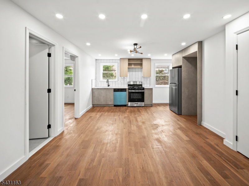 100 Chestnut Street, Unit 3 West Orange, NJ 07052 - Photo 2 of 18 a view of kitchen with refrigerator stove and wooden floor