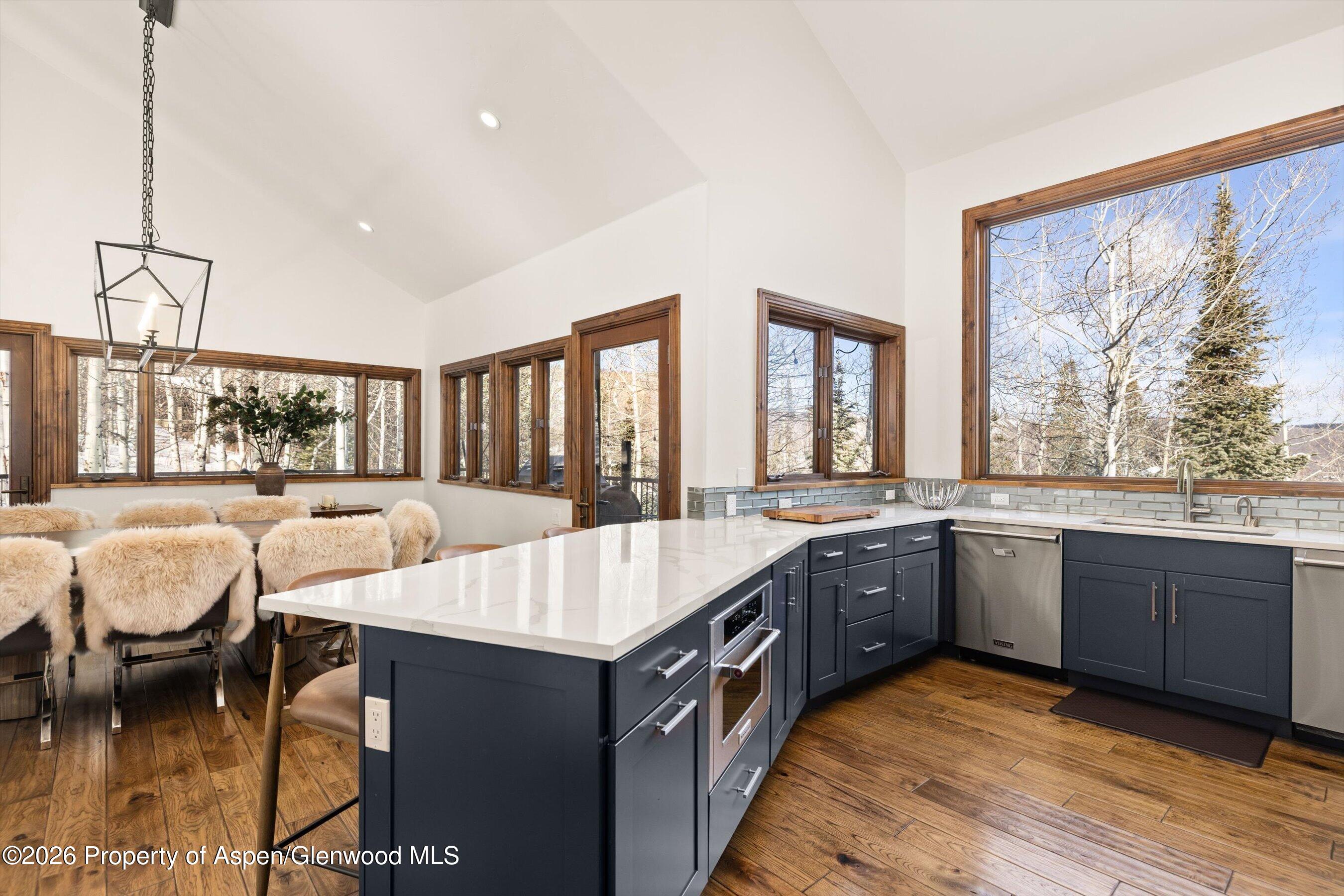 435 Faraway Road Snowmass Village, CO 81615 - Photo 11 of 35 a large kitchen with kitchen island granite countertop a island in the center and a stove