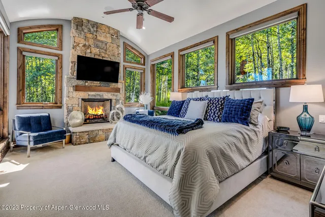 a bedroom with a bed and a fireplace