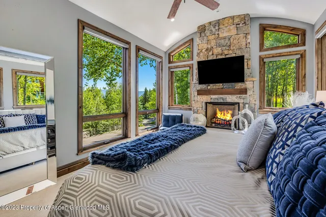 a living room with a flat screen tv and a fireplace