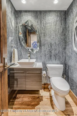 a bathroom with a toilet sink and mirror