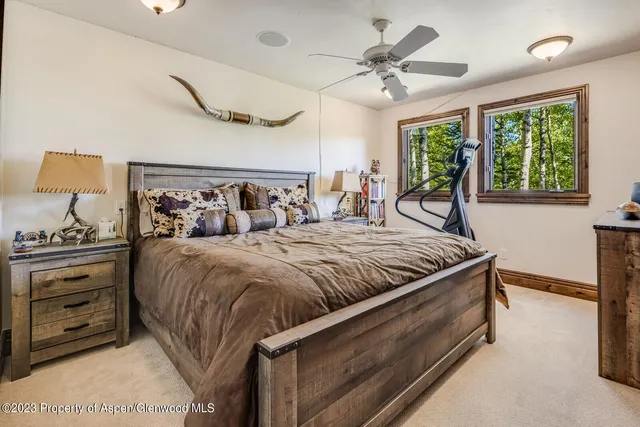 a bed sitting in a bedroom next to a window