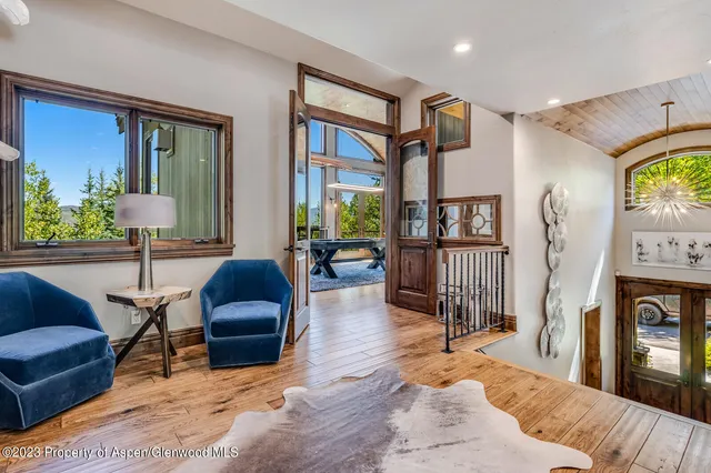 a living room with furniture fireplace and a large window