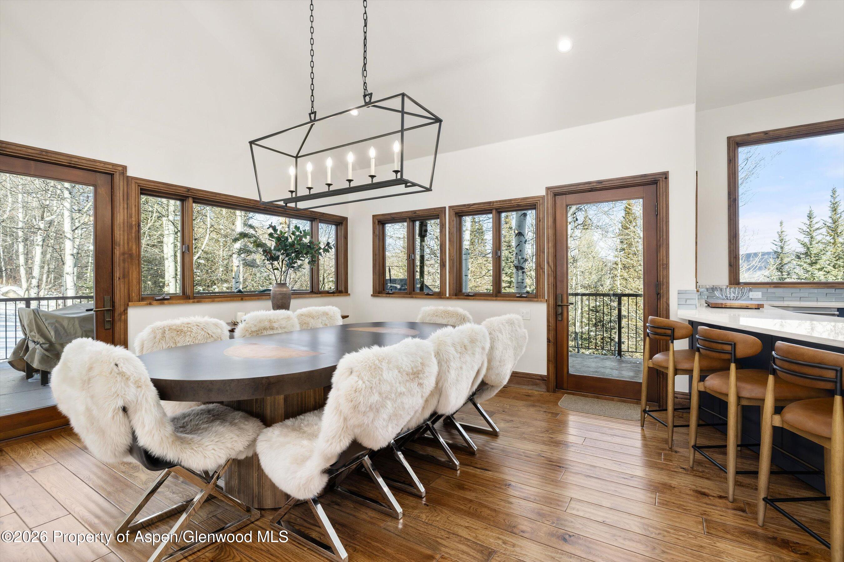 435 Faraway Road Snowmass Village, CO 81615 - Photo 8 of 35 a view of a dining room with furniture large windows and wooden floor