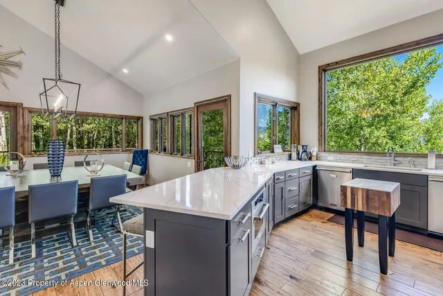a large dining space with furniture window and wooden floor