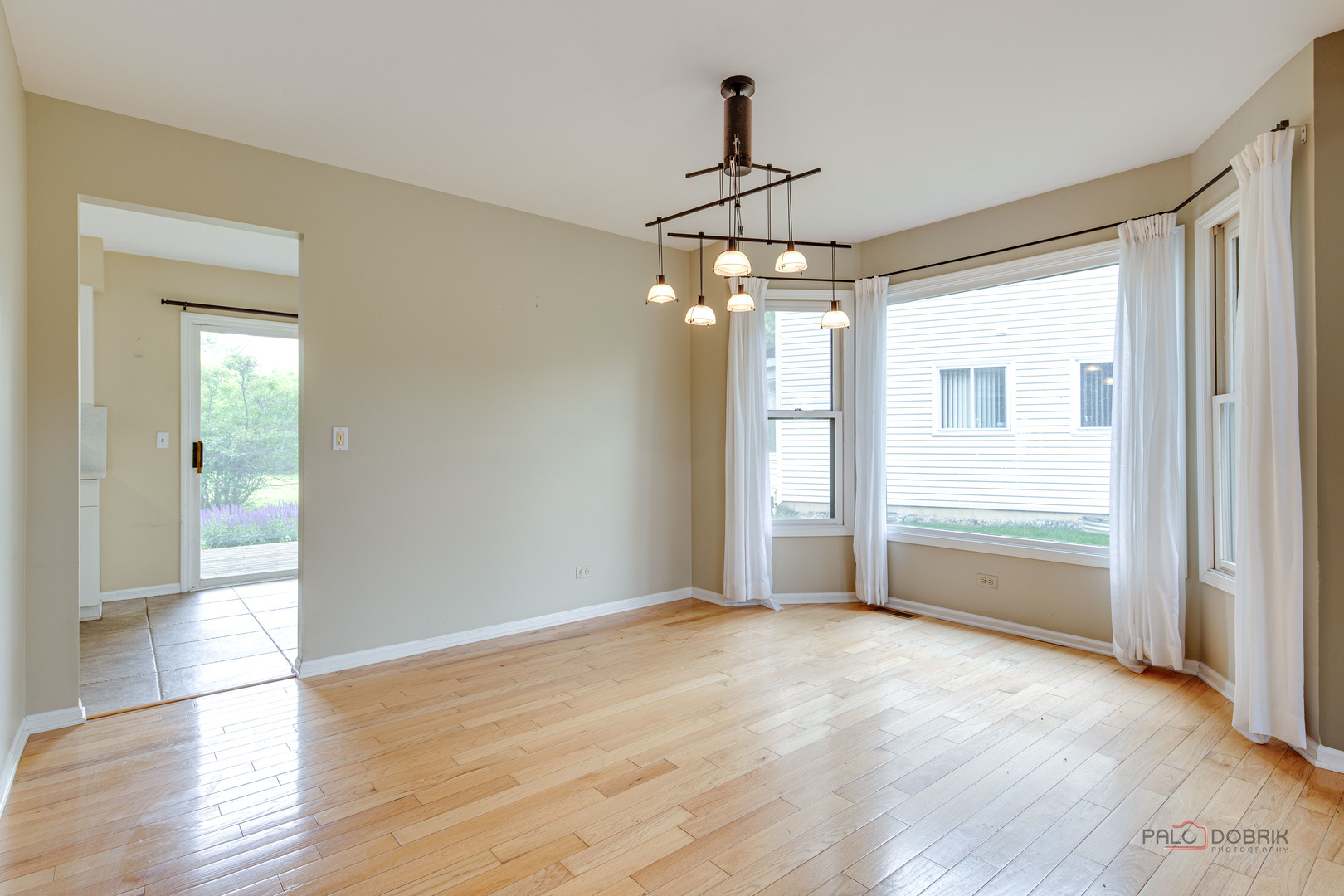 621 Raintree Road Buffalo Grove, IL 60089 - Photo 13 of 46 a view of a livingroom with a chandelier fan and windows