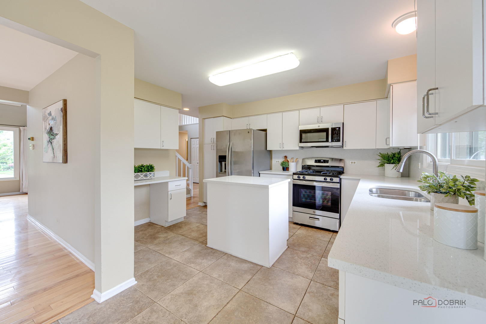 621 Raintree Road Buffalo Grove, IL 60089 - Photo 17 of 46 a kitchen with white cabinets and stainless steel appliances