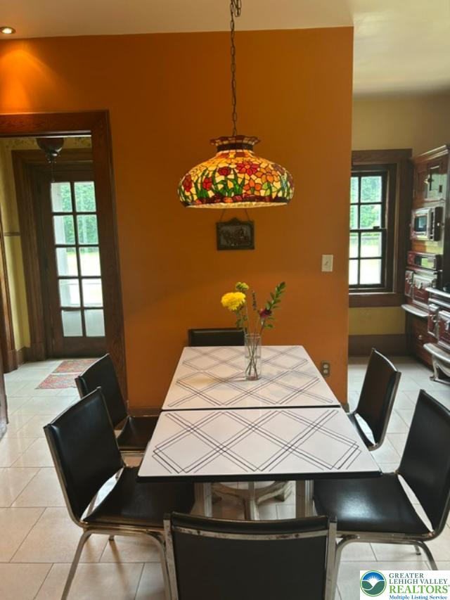 1170 Mosser Road Breinigsville, PA 18031 - Photo 7 of 19 A casual dining space features a unique stained-glass pendant light and tile flooring.
