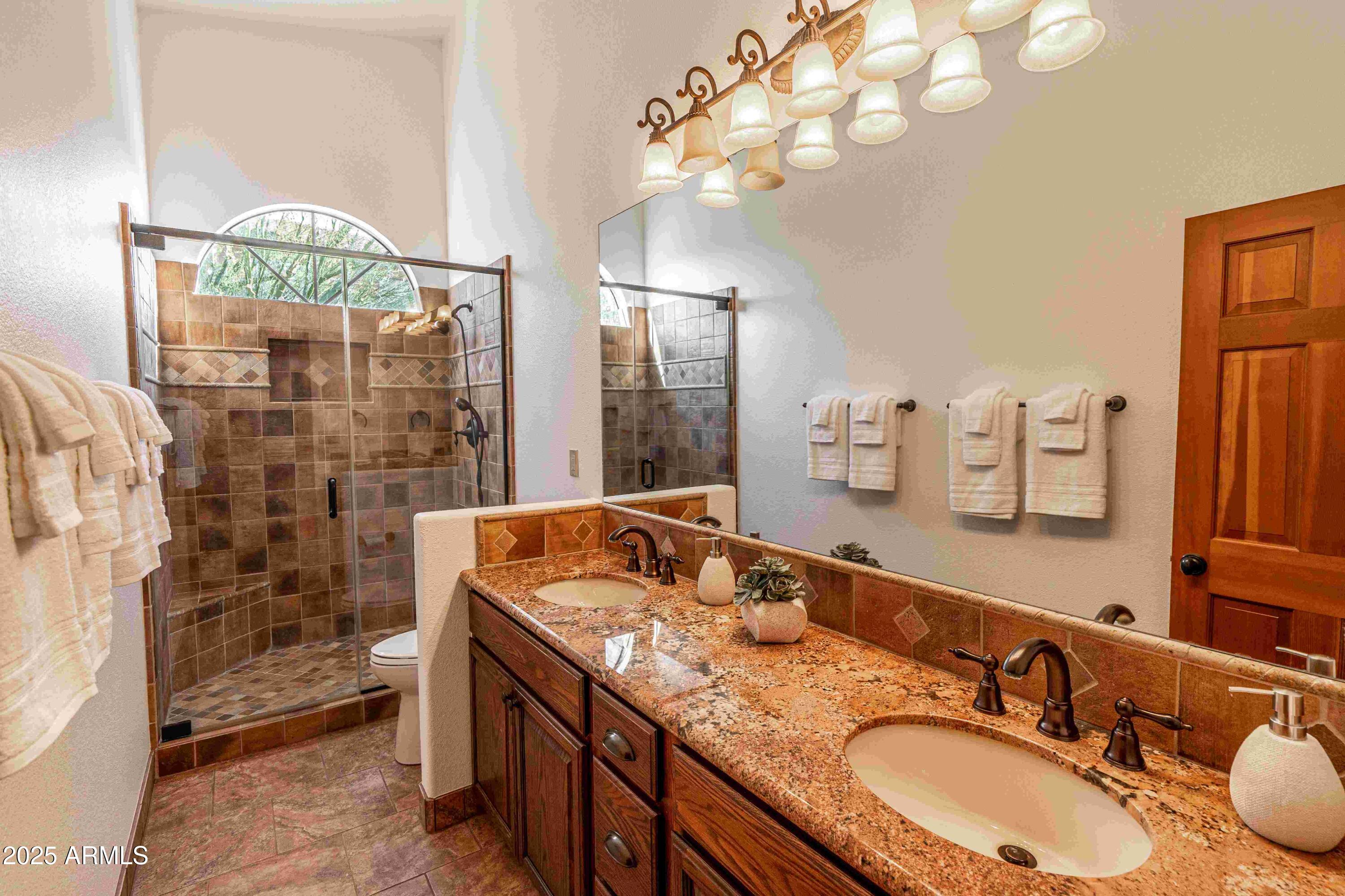 5426 East Libby Street Scottsdale, AZ 85254 - Photo 16 of 29 a bathroom with a granite countertop sink mirror and shower