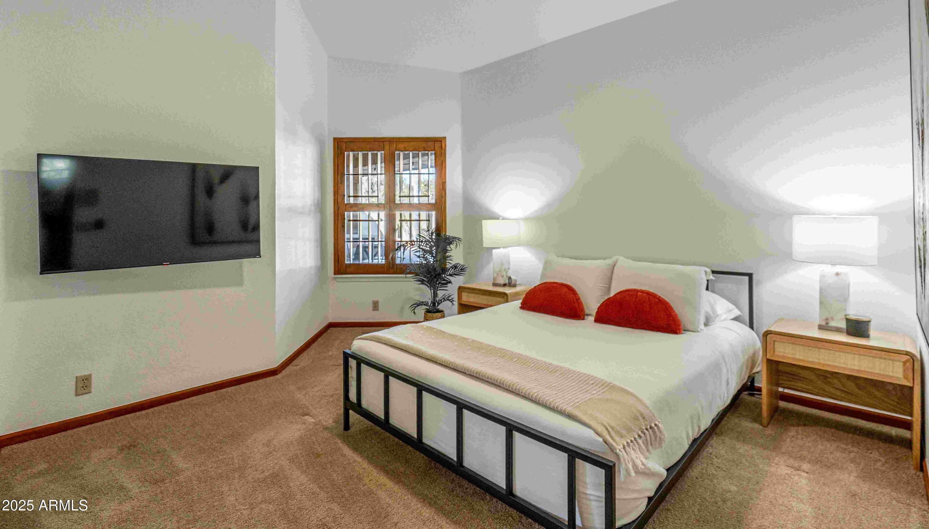 5426 East Libby Street Scottsdale, AZ 85254 - Photo 21 of 29 a bedroom with a bed and a flat screen tv