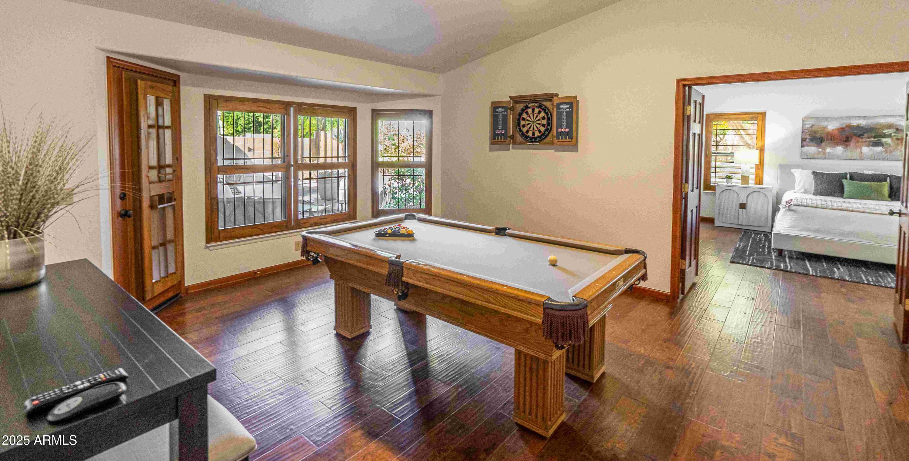5426 East Libby Street Scottsdale, AZ 85254 - Photo 10 of 29 a living room with furniture pool table wooden floor and a floor to ceiling window