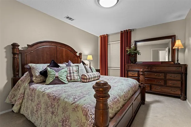 a bedroom with a bed and a dresser