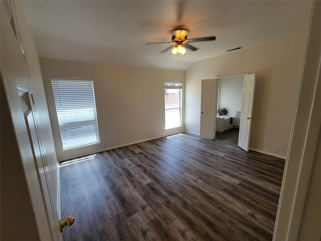 2913 Rush Creek Road McKinney, TX 75072 - Photo 5 of 32 Master with new laminate flooring, large walk-in closet and ceiling fan
