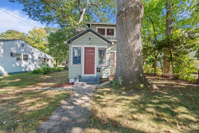 a front view of a house with garden