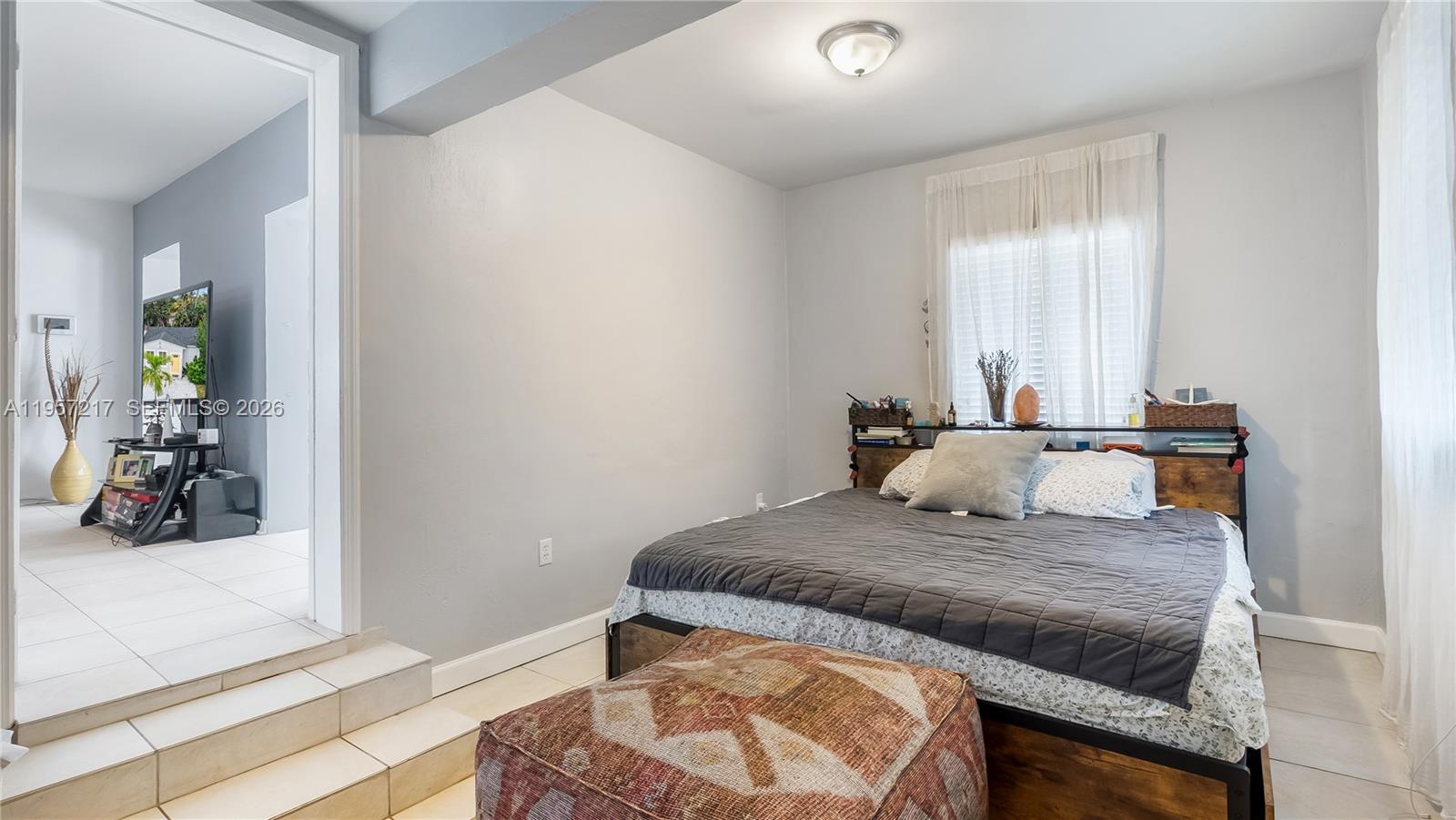 491 Northwest 108th Terrace Miami, FL 33168 - Photo 18 of 37 a bedroom with a bed and a window