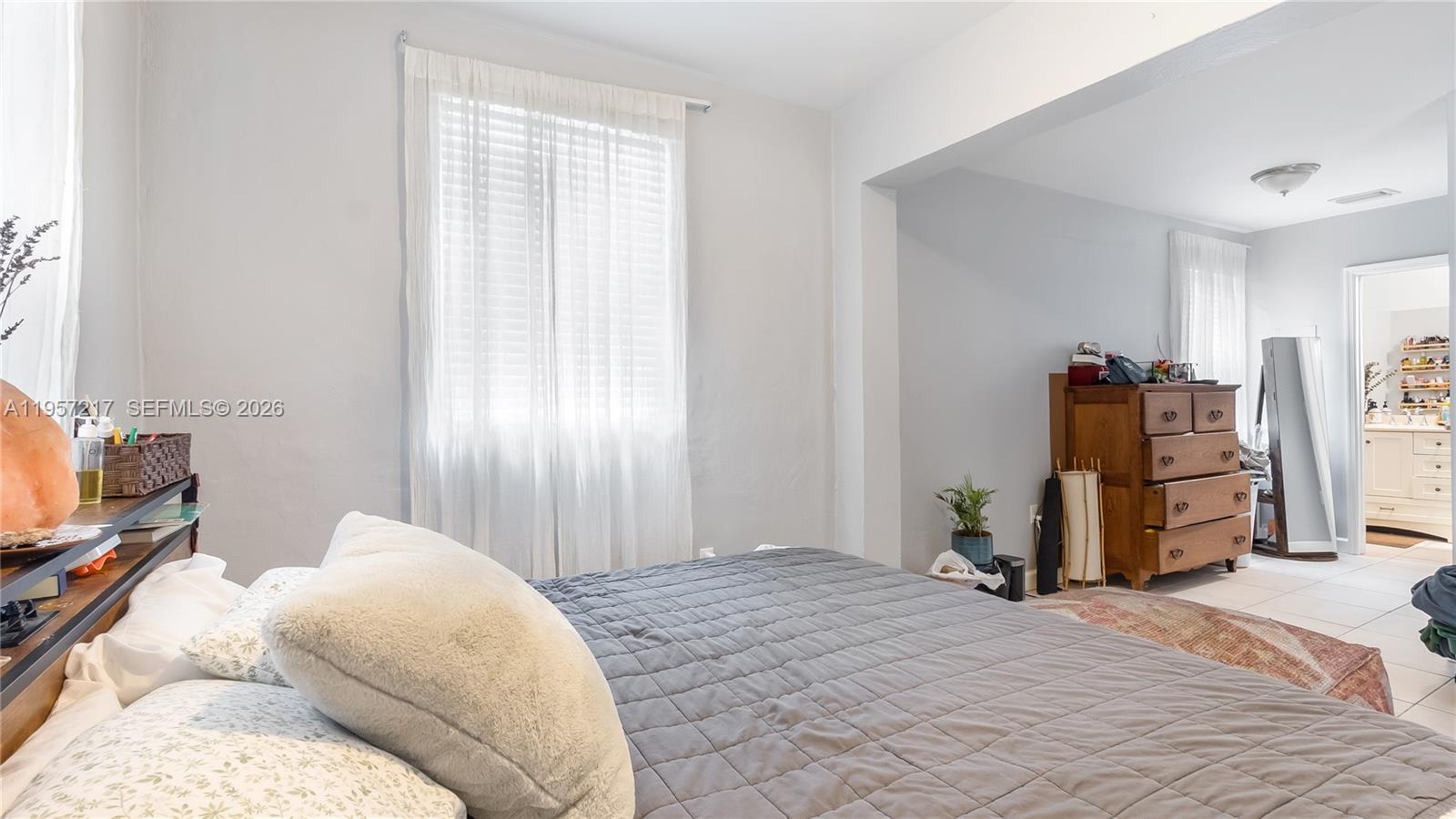 491 Northwest 108th Terrace Miami, FL 33168 - Photo 19 of 37 a bedroom with a bed and wooden floor