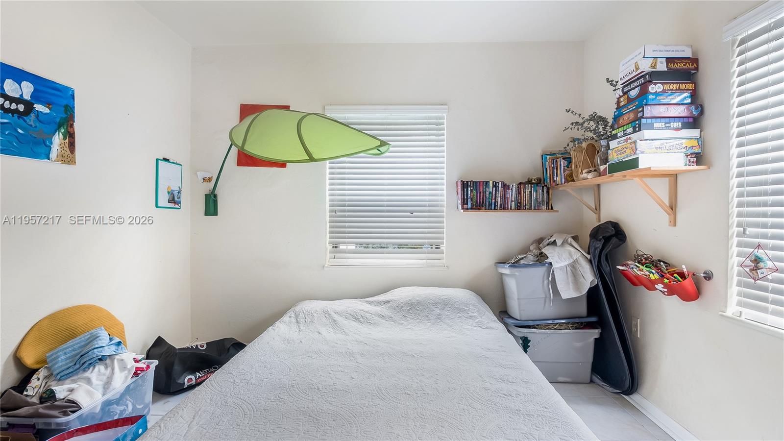 491 Northwest 108th Terrace Miami, FL 33168 - Photo 28 of 37 a bedroom with a bed and a window