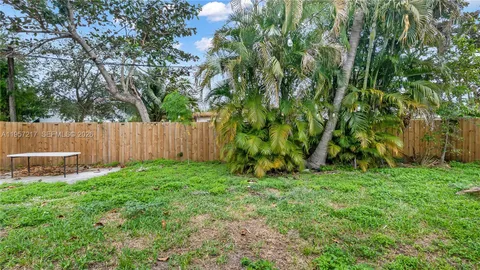 a view of a backyard with a fence