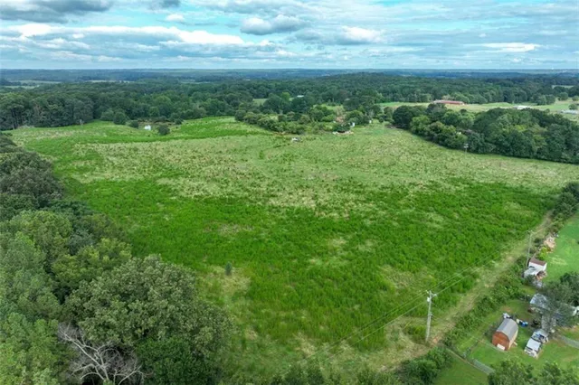 a view of a big yard with lots of green space