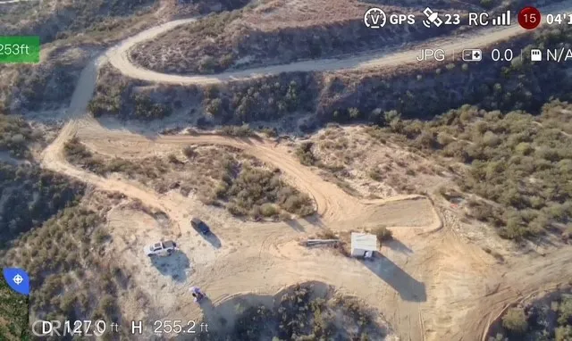 a view of a dry yard with trees