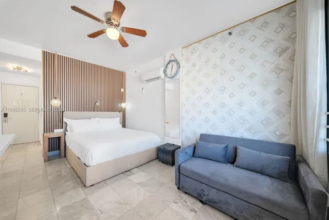 a bedroom with a bed couch and window