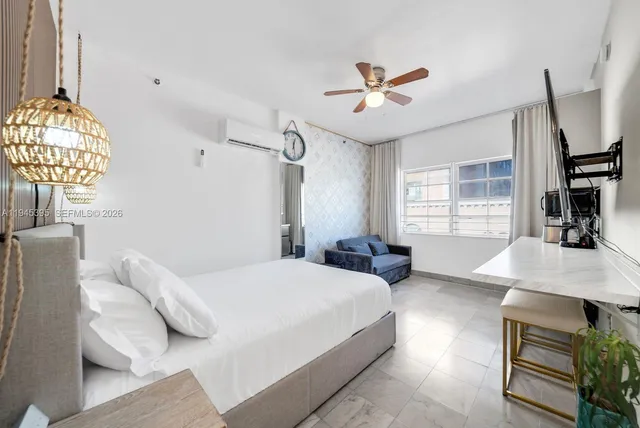 a bedroom with a bed mirror and window