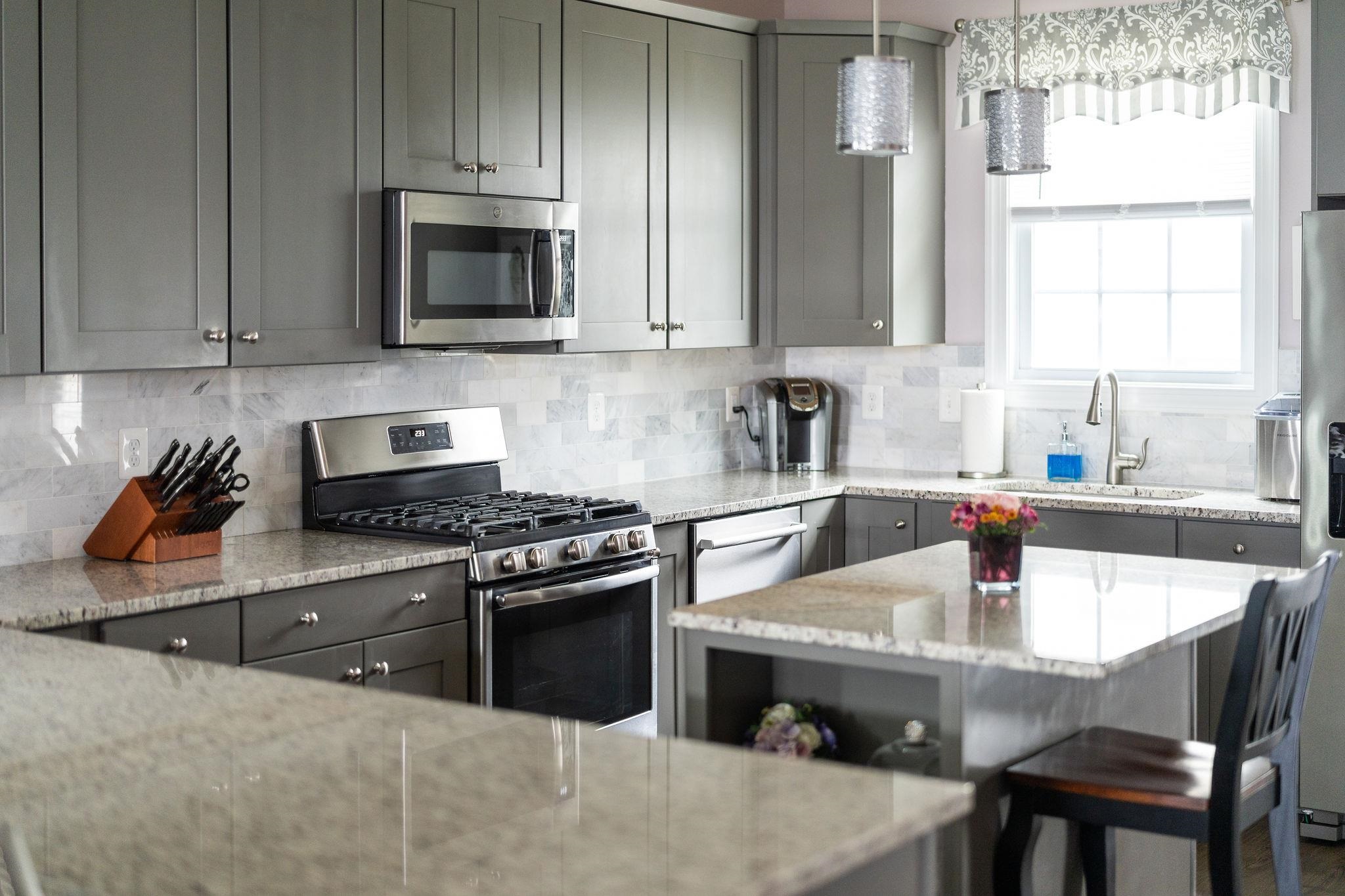 1644 Delphi Drive Charlottesville, VA 22911 - Photo 11 of 39 a kitchen with stainless steel appliances a stove a sink and a microwave