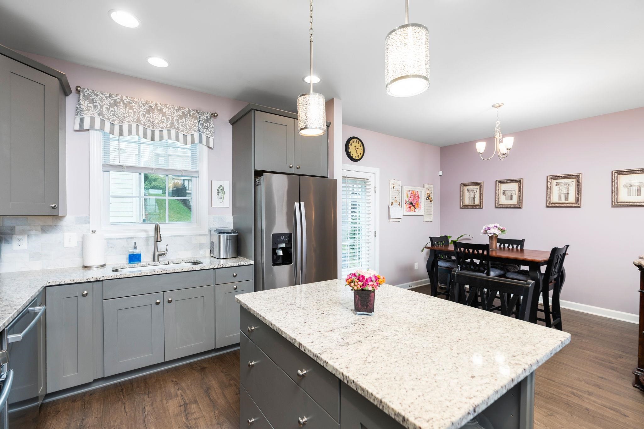 1644 Delphi Drive Charlottesville, VA 22911 - Photo 14 of 39 a kitchen with stainless steel appliances kitchen island granite countertop a sink a refrigerator and wooden cabinets