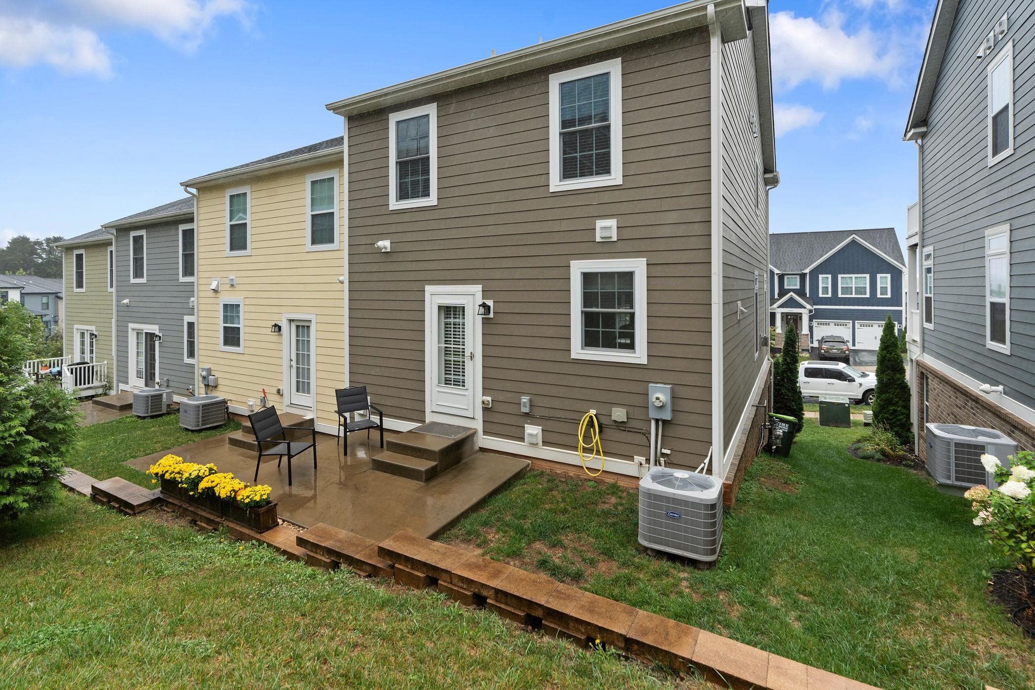 1644 Delphi Drive Charlottesville, VA 22911 - Photo 37 of 39 a front view of a house with garden and chairs