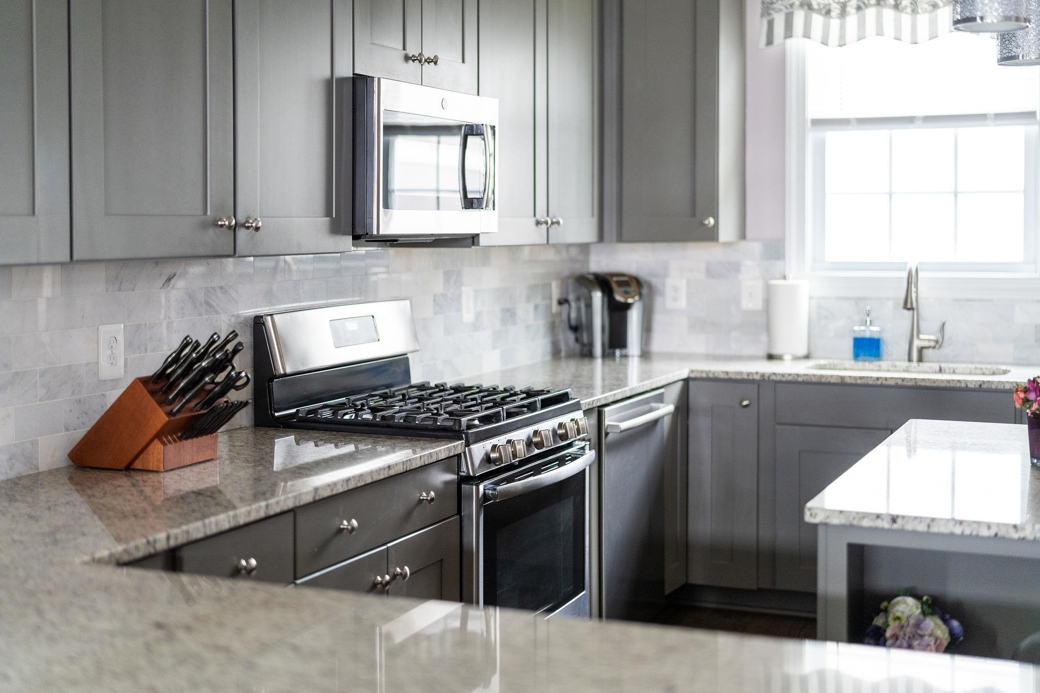1644 Delphi Drive Charlottesville, VA 22911 - Photo 8 of 39 a kitchen with stainless steel appliances granite countertop a stove a sink and a microwave
