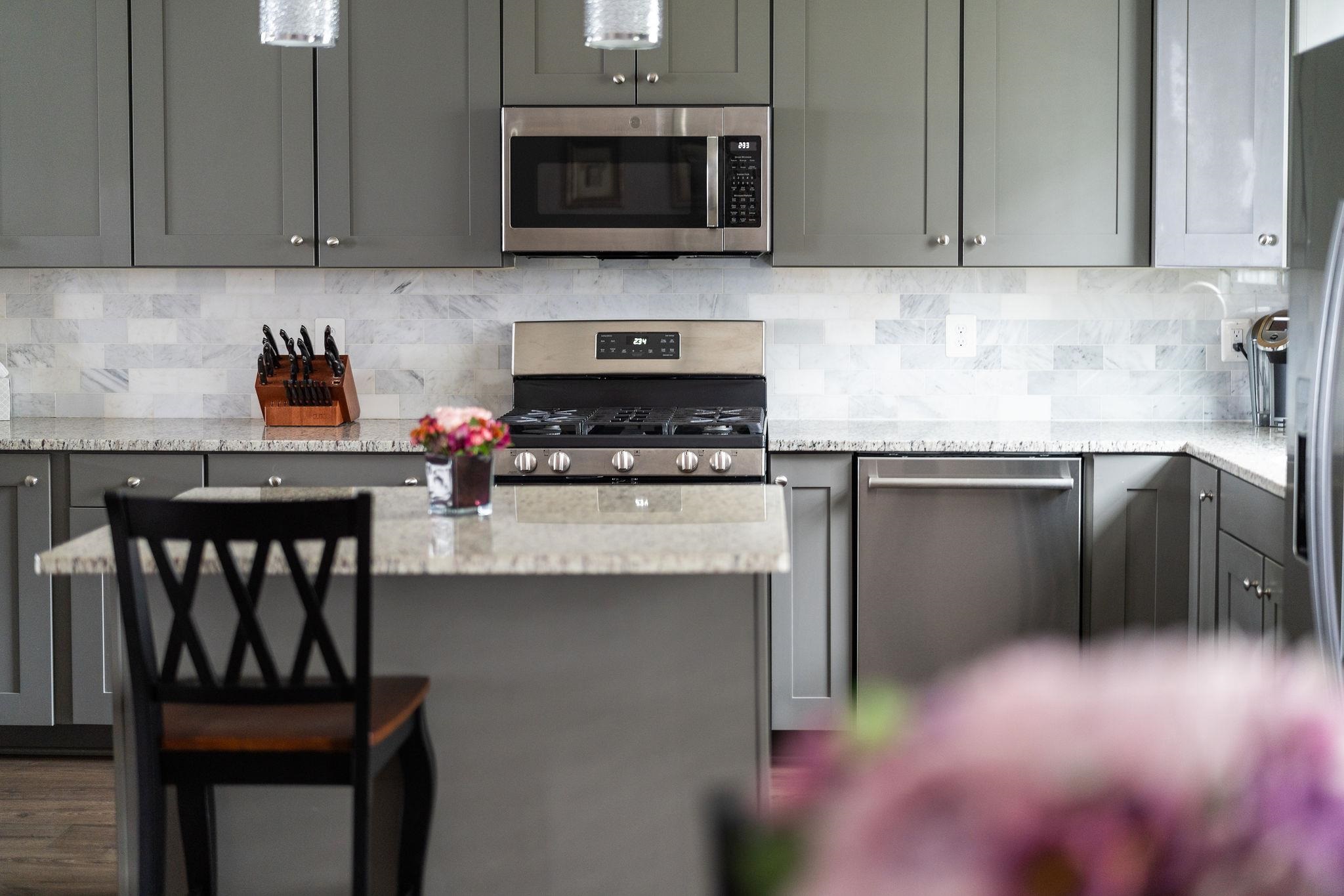 1644 Delphi Drive Charlottesville, VA 22911 - Photo 10 of 39 a kitchen with stainless steel appliances granite countertop a stove a sink and a microwave