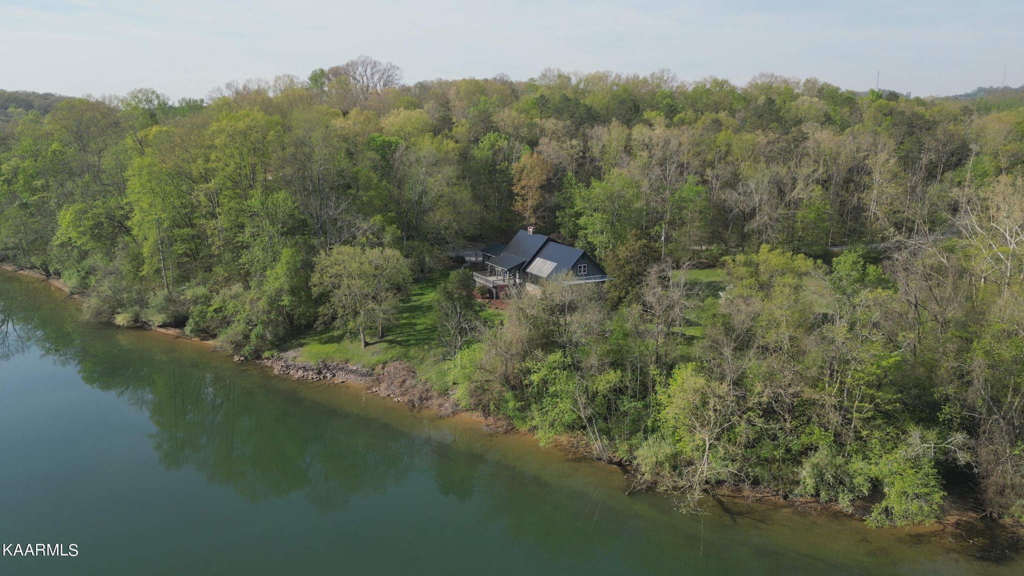 2532 Jones Road Lenoir City, TN 37771 - Photo 5 of 9 a view of a lake with a mountain and trees in the background