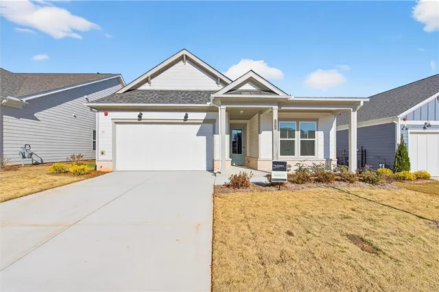 a view of a house with wooden fence