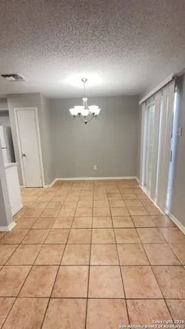 a view of a livingroom with an empty space and a window